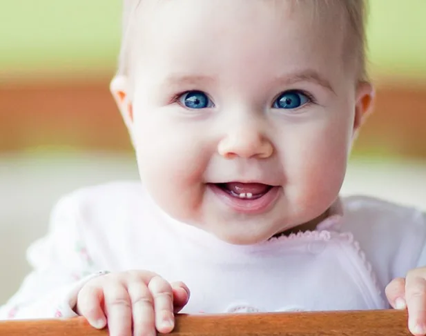 A smiling baby - the first visit to the dentist